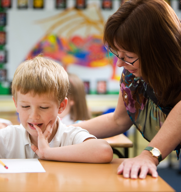 A teaching assistant talking to a child