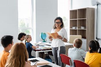 A teacher reading a book to students